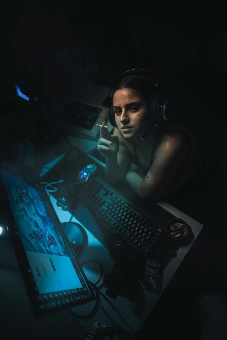 Intense gaming session with a female gamer at her setup during night time.